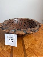 Front and angled top view of the red gum burl wood bowl, showing textured natural burl patterns and rugged rim edges.