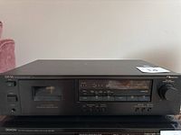 Front view of the Nakamichi CR-1A cassette deck showing the entire front panel including cassette window, buttons, and level meter.