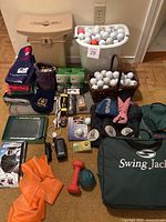 Full display of assortment showing all main items including golf balls, towels, cooler seat and Swing Jacket bag