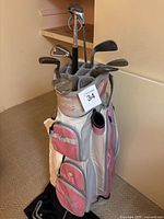 Full view of the pink and white Golf Trends ladies golf bag with various golf clubs inside, showing the condition and full contents.