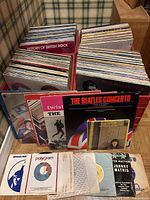 Four crates filled with vinyl record jackets front and center