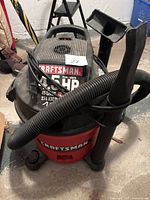 Full view of Craftsman shop vacuum with hose and blower attachments showing overall design and condition.