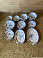 Grouping of all bowls, plates and platters on floor