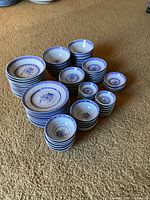 Full overview of all dish stacks on carpet floor