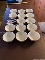 Top-down view showing 14 bowls and 3 spoons arranged