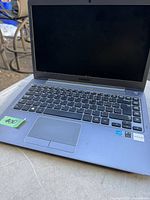 Open laptop showing keyboard and screen with Samsung branding below the display.