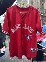Front of red Toronto Blue Jays jersey with 'Blue Jays' text and team logo.
