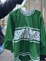 Front view of a green Toronto St. Pats hockey jersey with white and green trim, displaying the team name on the chest.