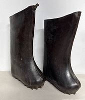Pair of black antique Asian rice paddy boots shown from front angle, textured material and rugged sole visible