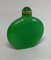 Green spinach jadeite snuff bottle front view showing rounded rectangular shape and smooth texture