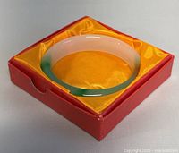 Natural jade D-shaped bangle bracelet displayed in original red box with golden-yellow satin lining.