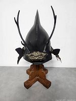 Front view of helmet mounted on wooden stand