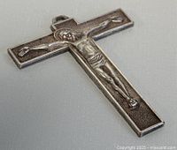 Front view of the silver plated crucifix pendant showing detailed Jesus figure and textured background.