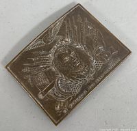 Front angled view showing embossed Abraham Lincoln profile with flags, eagle, and weapons