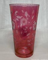 Front view of 12-inch vintage cranberry colored vase with etched floral and leaf motifs