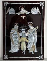 Front view of vintage religious wall art with mother of pearl inlay on dark lacquered wood.