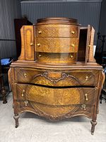 Front view of entire dresser showing bottom drawers, top curved drawers and side cubby doors