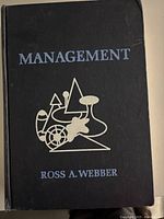 Front cover of a hardcover book titled Management by Ross A. Webber with abstract silver graphic design.