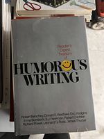 Photo of hardcover book titled 'Reader's Digest Treasury of Humorous Writing' with authors listed on dust jacket.