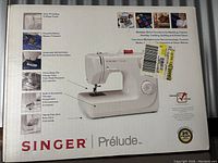 Original box for Singer Prelude Model 8280 sewing machine showing multiple features and warranty information.