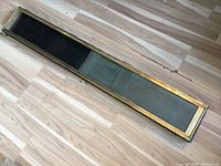 Top view of brass and glass mail chute insert showing length and construction.