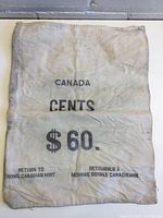 Full view of the large off-white cloth money bag stamped with 'CANADA', 'CENTS', and '$60', with instructions for return to Royal Canadian Mint.