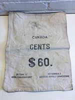Full view of the cloth money bag showing printed text indicating it is for Canadian cents worth $60, made by the Royal Canadian Mint.
