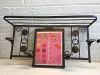 Front view of the metal European-style wall-mount coat hanger shelf showing structural details and rack top.