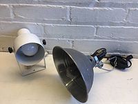 Two task lights displayed: white wall-mount light and gray aluminum clip-on light showing shape and wiring.