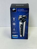 Box front showing the 9D Contour Detect Technology electric shaver branding and image of the shaver.