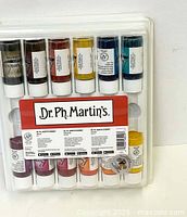 Top view of the complete set of Dr. Ph. Martin's Bombay India Ink bottles in plastic packaging showing multiple colors and labels.