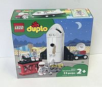 Front view of LEGO Duplo Space Shuttle Mission puzzle set box with 23 pieces, space shuttle, launch pad, and astronaut figures shown on packaging.