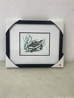 Framed turtle art print in protective corner covers, showing front view.