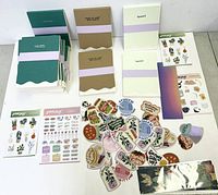 Overview of all items in the lot including multiple blank notebooks, sheets of stickers, die-cut stickers, and several bookmarks.