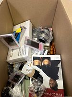 Overall top view of box showing false eyelash sets, boxed items, and various product packaging.