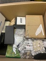 View showing assorted packaging with fashion jewelry items, some small boxes, and plastic bags with jewelry or accessory parts.