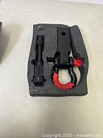 Top view of shackle hitch and accessory tool in foam insert