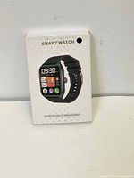 Front of the new boxed smart watch showing watch image and interface on screen with time, date, icons for health and activity apps.