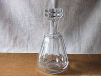 Front view of the Baccarat crystal decanter showing the tapering body with panel cuts and original stopper in place.