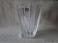 Front view of clear crystal tulip vase with label visible and scalloped edges.