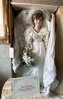 Front view of the Princess Diana Bride Doll in original box, wearing white bridal gown, tiara, and holding bouquet.