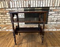 Front view of vintage mahogany side table with shelf and magazine rack