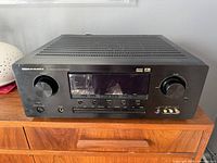 Front view of the Marantz AV Surround Receiver SR5200 showing overall unit with volume and surround knobs, input buttons, headphone jack, and display screen.