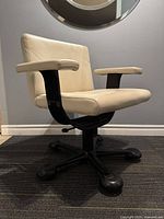 Angled front-left view showing seat, backrest, armrests, base