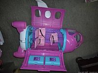 Open view from top showing two pink seats inside plane cabin and interior details