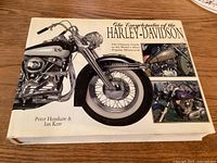 Front cover of the book showing a large image of a classic Harley-Davidson motorcycle with details on the dust jacket titled 'The Encyclopedia of the Harley-Davidson'.