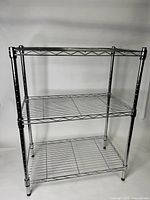 Full view of the 3-tier aluminum wire baking rack showing three shelves and tubular legs with adjustable feet.