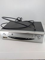 Front and top view of GE VCR unit with attached coax cable