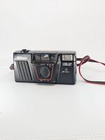 Front view of Nikon L135 AF camera showing lens, flash, strap and branding.