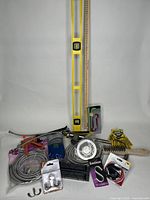 Overview of plumbing and installation tools including levels, faucet, hoses, hooks, and caulking tool